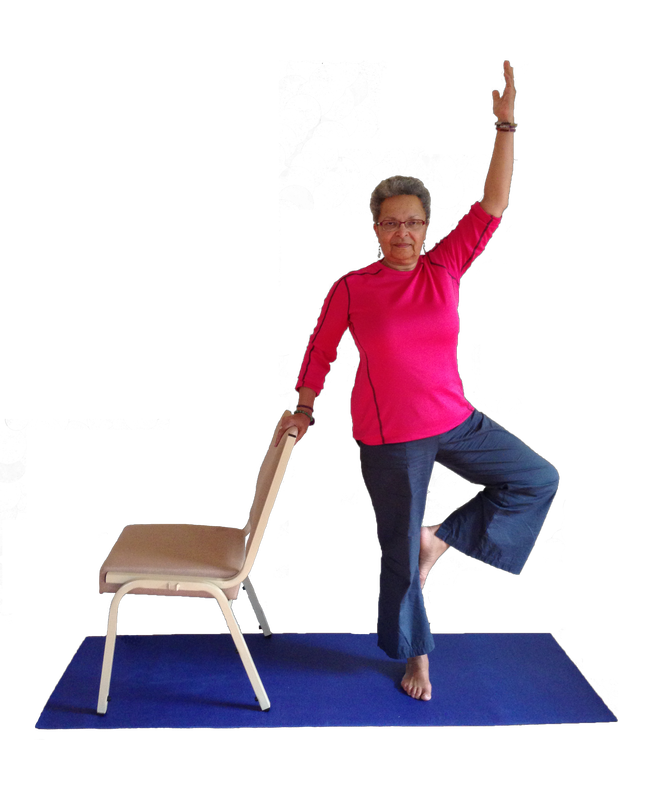 Beth holding onto chair for support while in yoga stance